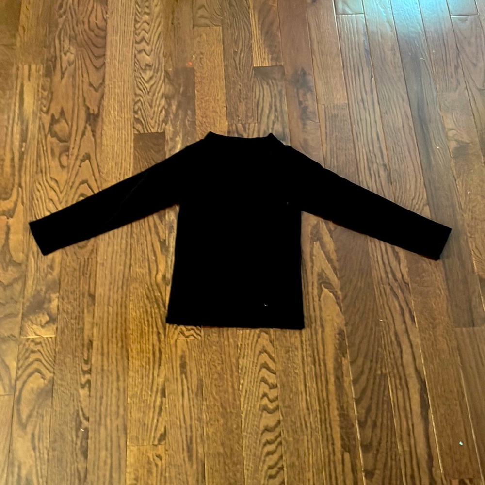 Black long sleeve shirt with triangular hole from neck to top of chest.